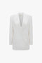 An Exclusive Double Breasted Tuxedo Jacket In Ivory by Victoria Beckham with peaked lapels and two front pockets, perfect for black-tie occasions, displayed on a plain white background.