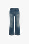 A pair of Victoria Beckham Cropped Kick Jeans in Indigrey Wash with a flared silhouette and a faded wash, isolated on a white background.