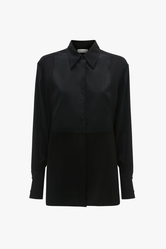 A black, tuxedo-inspired button-down long-sleeve shirt with a collar and buttoned cuffs exudes modern femininity in the form of the Contrast Bib Shirt In Black by Victoria Beckham.