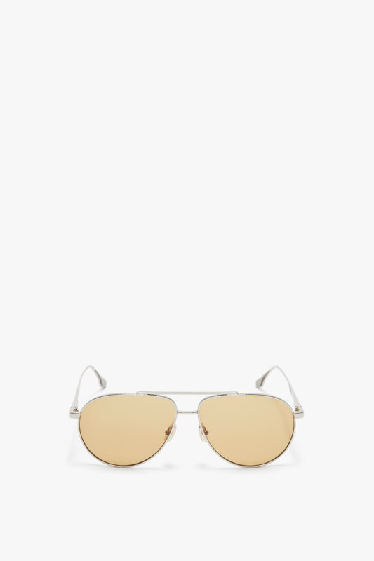 A pair of Victoria Beckham V Metal Pilot Sunglasses In Silver-Brown, with a thin silver frame and light brown tinted lenses, isolated on a white background.