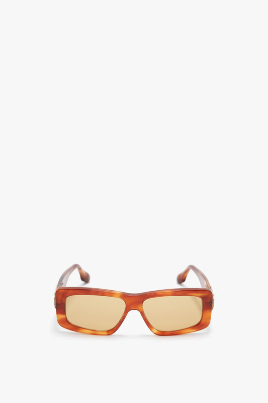 Victoria Beckham Chain Detail Rectangular Frame Sunglasses In Striped Blonde Havana, featuring amber lenses and a subtle chain detail on the arms, viewed from the front against a plain white background.