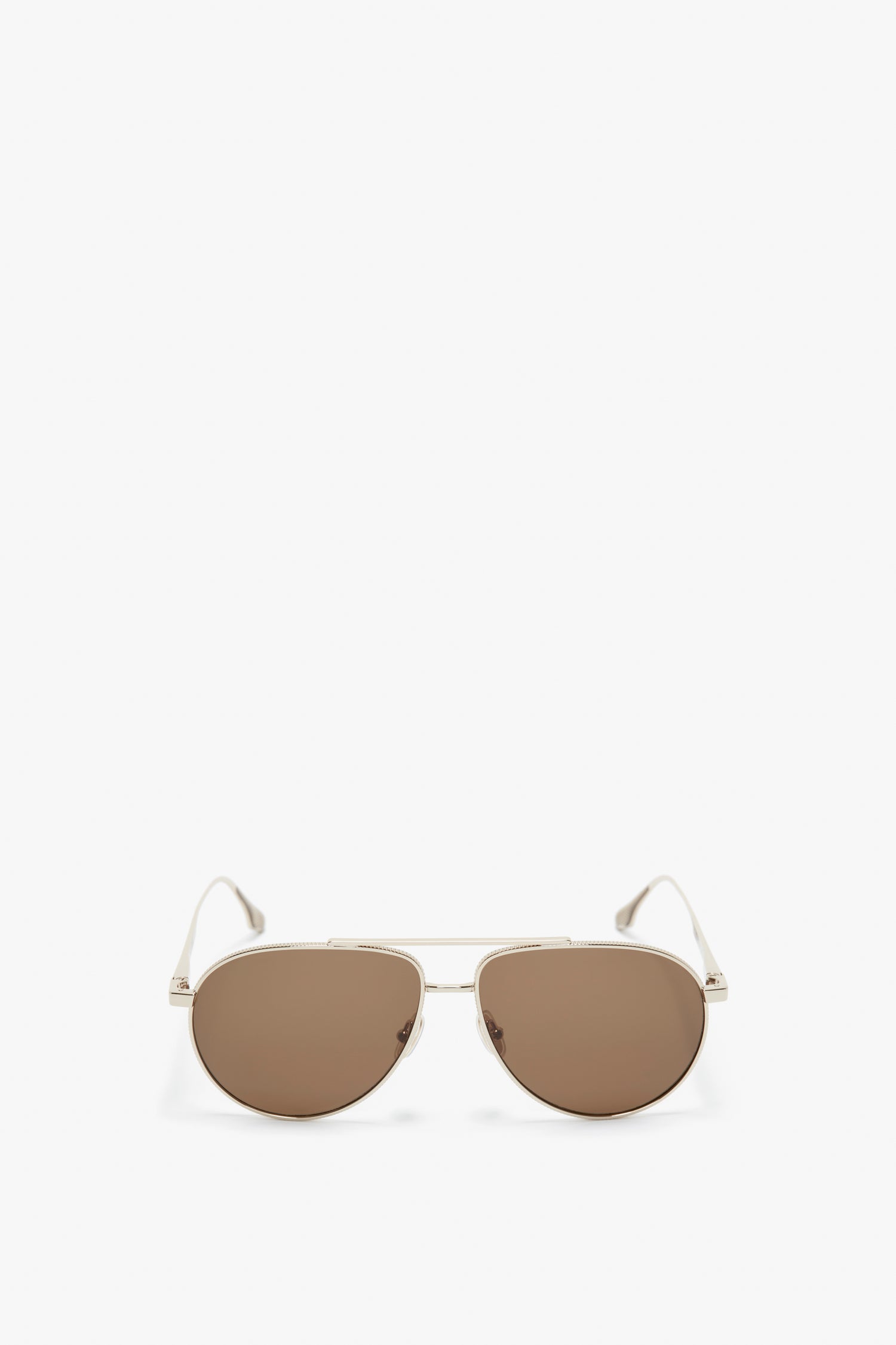 A pair of V Metal Pilot Sunglasses In Gold-Khaki by Victoria Beckham with thin metallic frames and brown-tinted lenses, featuring adjustable nose pads, positioned against a plain white background.