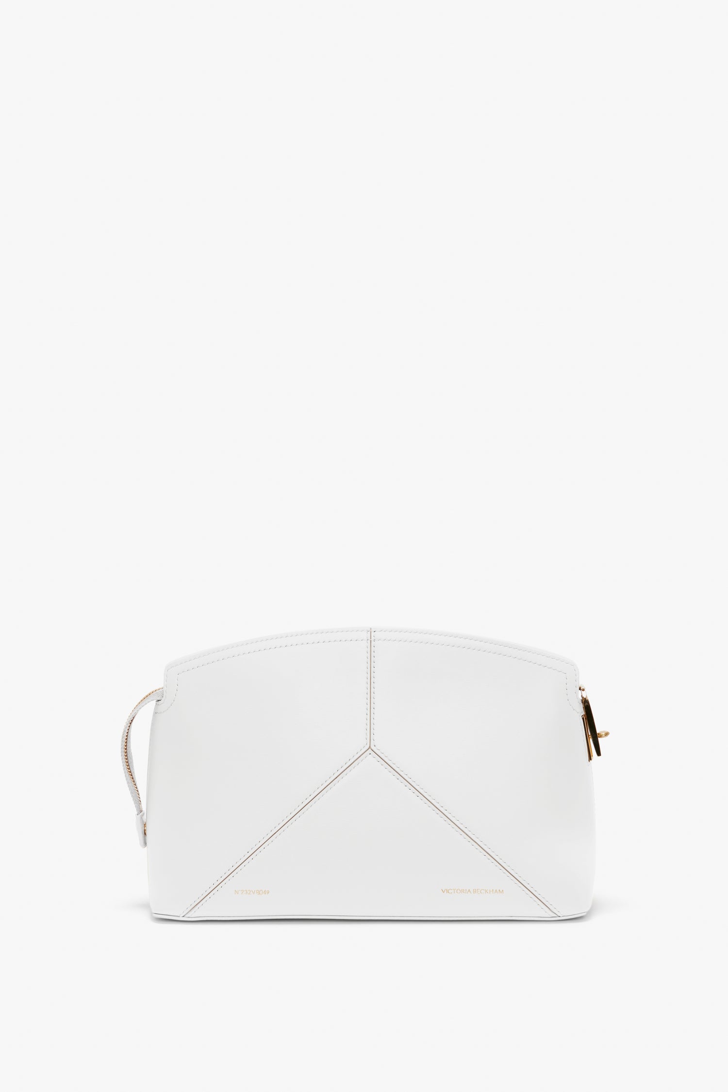 A white geometric handbag with gold hardware and minimal stitching, featuring a top-zip closure and a branded padlock for added security.
Product Name: Exclusive Victoria Clutch Bag In White Leather Brand Name: Victoria Beckham

Replaced Sentence:
The Exclusive Victoria Clutch Bag In White Leather by Victoria Beckham features a white geometric design with gold hardware and minimal stitching, complemented by a top-zip closure and a branded padlock for added security.