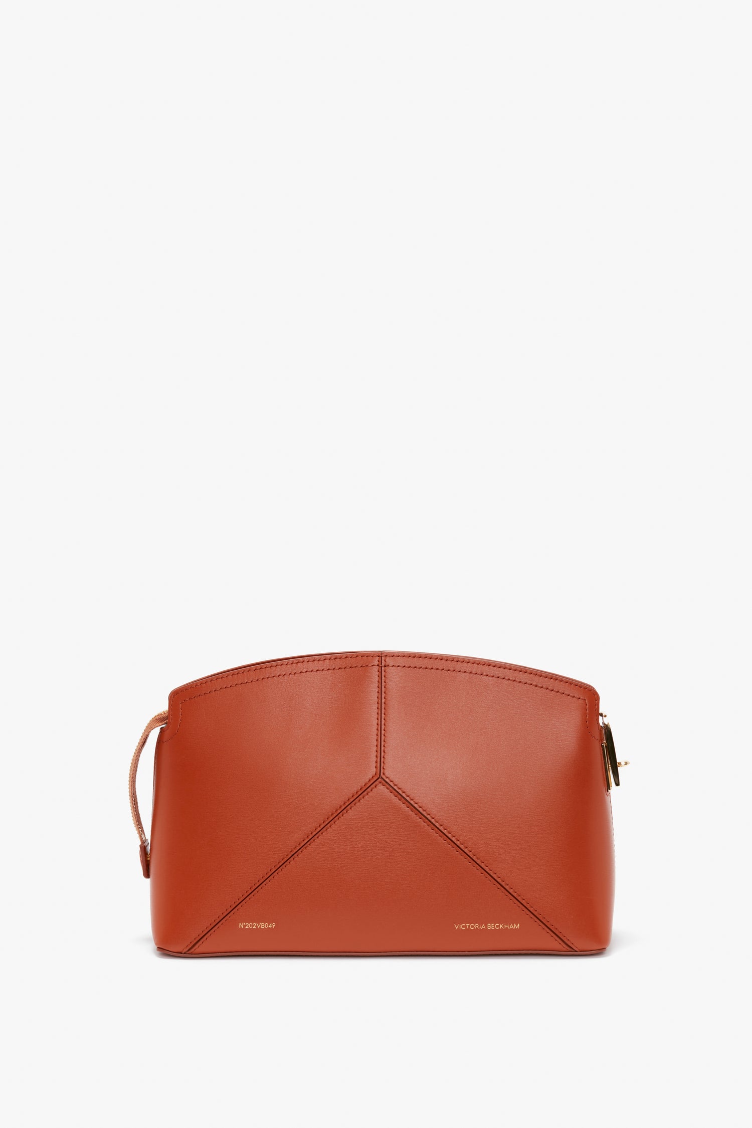 A structured Victoria Beckham Victoria Clutch Bag In Tan Leather with a top zip closure, geometric panel design, and a small strap on one side.