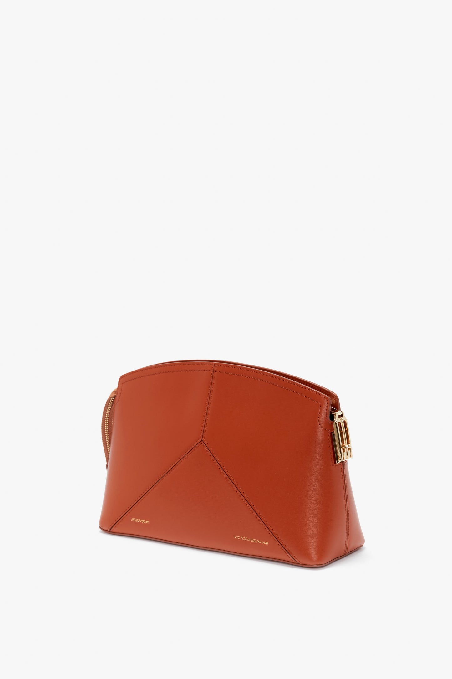 A Victoria Beckham Victoria Clutch Bag In Tan Leather with geometric stitching, a gold-toned clasp, and a sophisticated branded padlock on a white background.