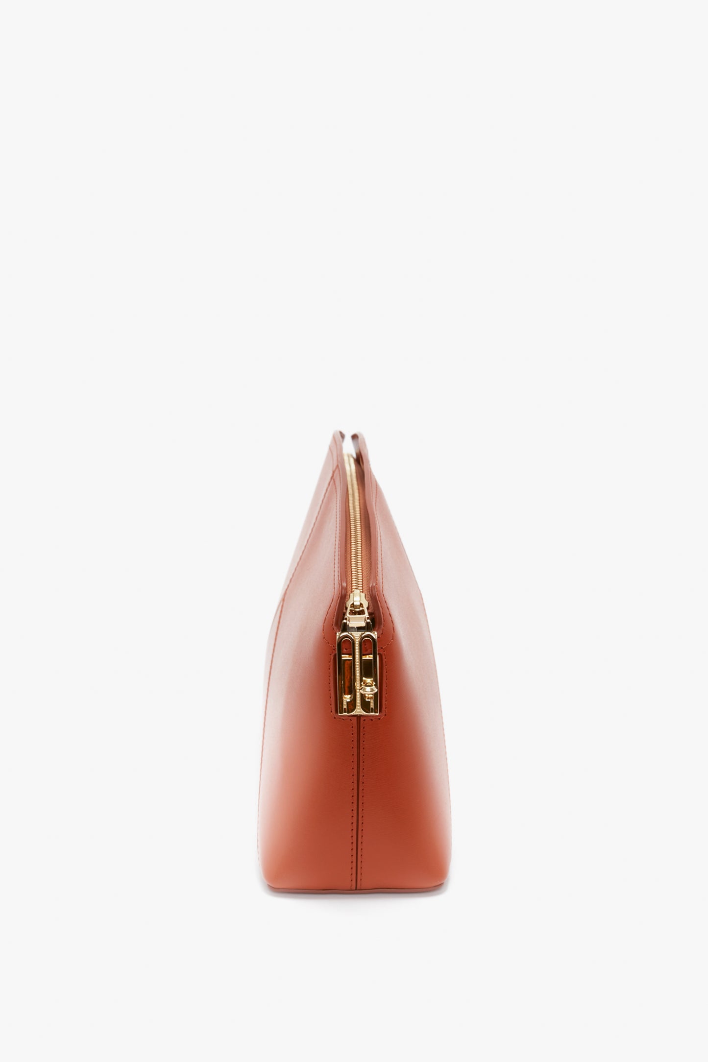 Side view of a closed, rectangular, Victoria Clutch Bag In Tan Leather by Victoria Beckham with a gold zipper and a branded padlock against a white background.