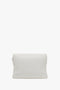 A plain white Victoria Beckham Puffy Chain Pouch Bag With Strap In White Leather is shown against a white background. The bag has a clean, minimalist look with no visible branding or embellishments but features a detachable shoulder strap for versatility.