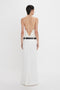 A person wearing an Exclusive Cami Top In Ivory by Victoria Beckham, standing facing away against a white background.