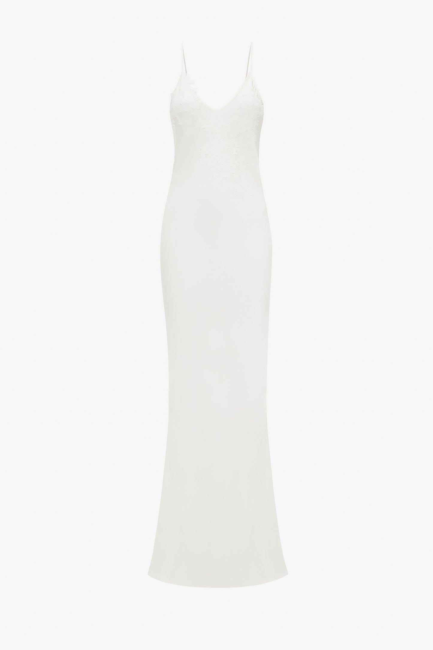 A white, sleeveless, floor-length evening dress with lace appliqué on the bodice, displayed against a white background by Victoria Beckham's Exclusive Lace Detail Floor-Length Cami Dress In Ivory.