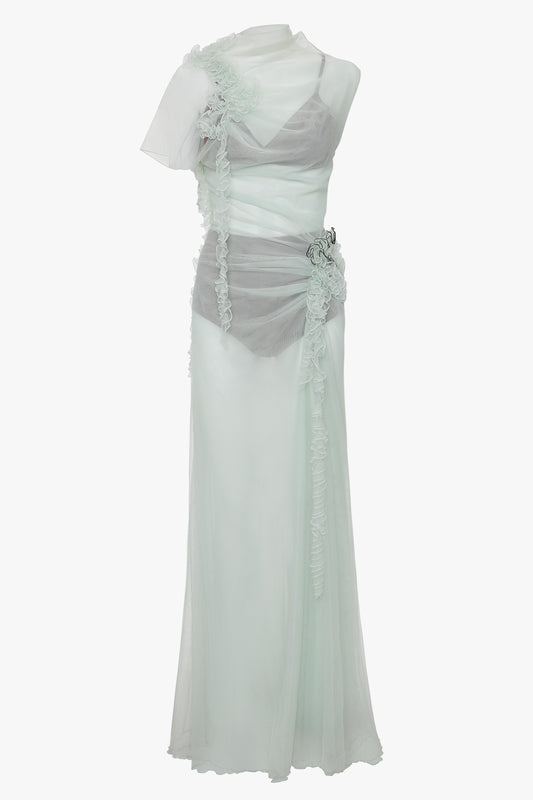 A Victoria Beckham Gathered Tulle Detail Floor-Length Dress In Jade with sheer and ruffled detailing, featuring one short sleeve and a cinched waist with floral ruche detailing for an ethereal gown look.