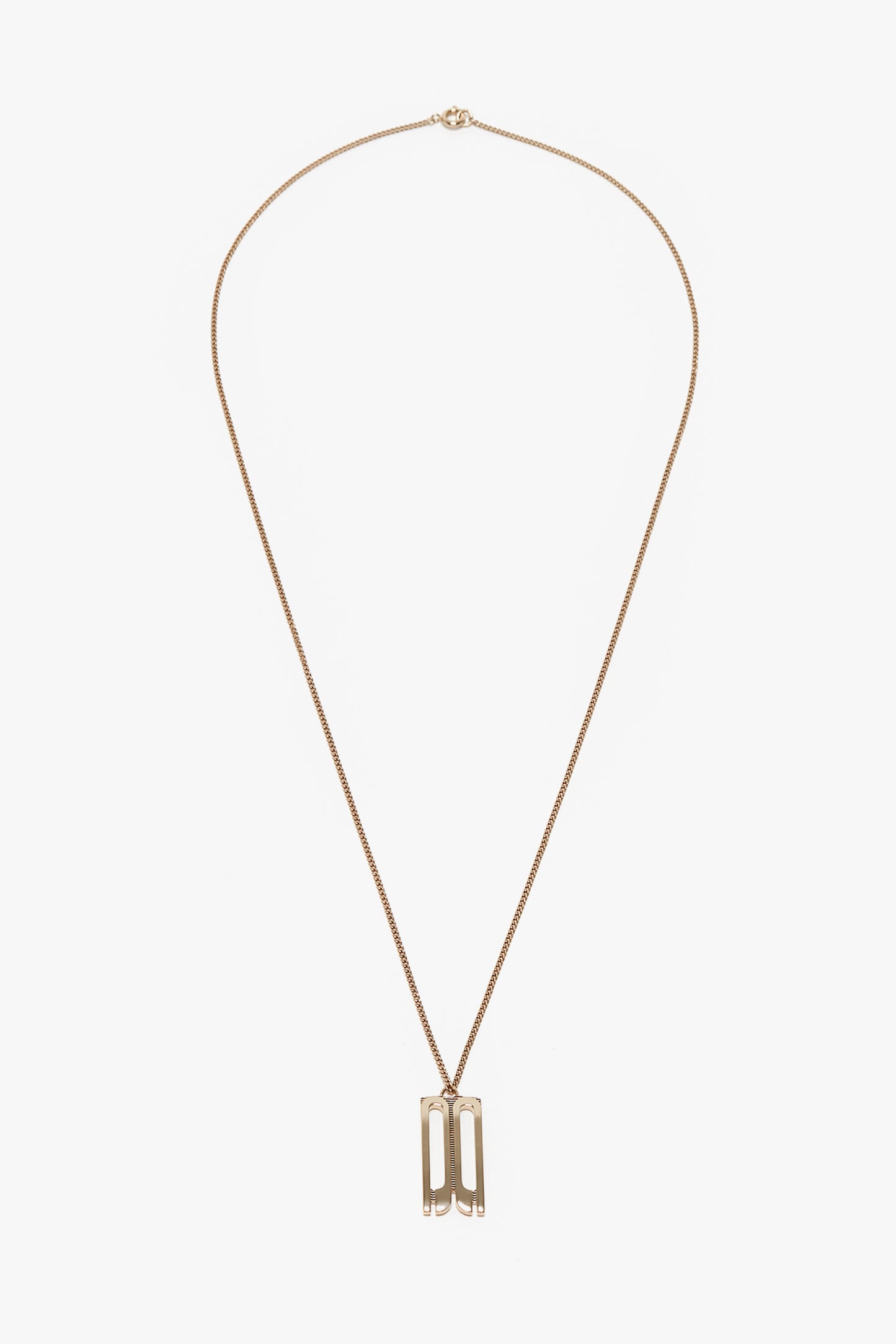 A gold-plated brass necklace with a thin chain featuring a rectangular Frame Charm Pendant designed with cut-out shapes, the Exclusive Frame Necklace In Gold by Victoria Beckham.