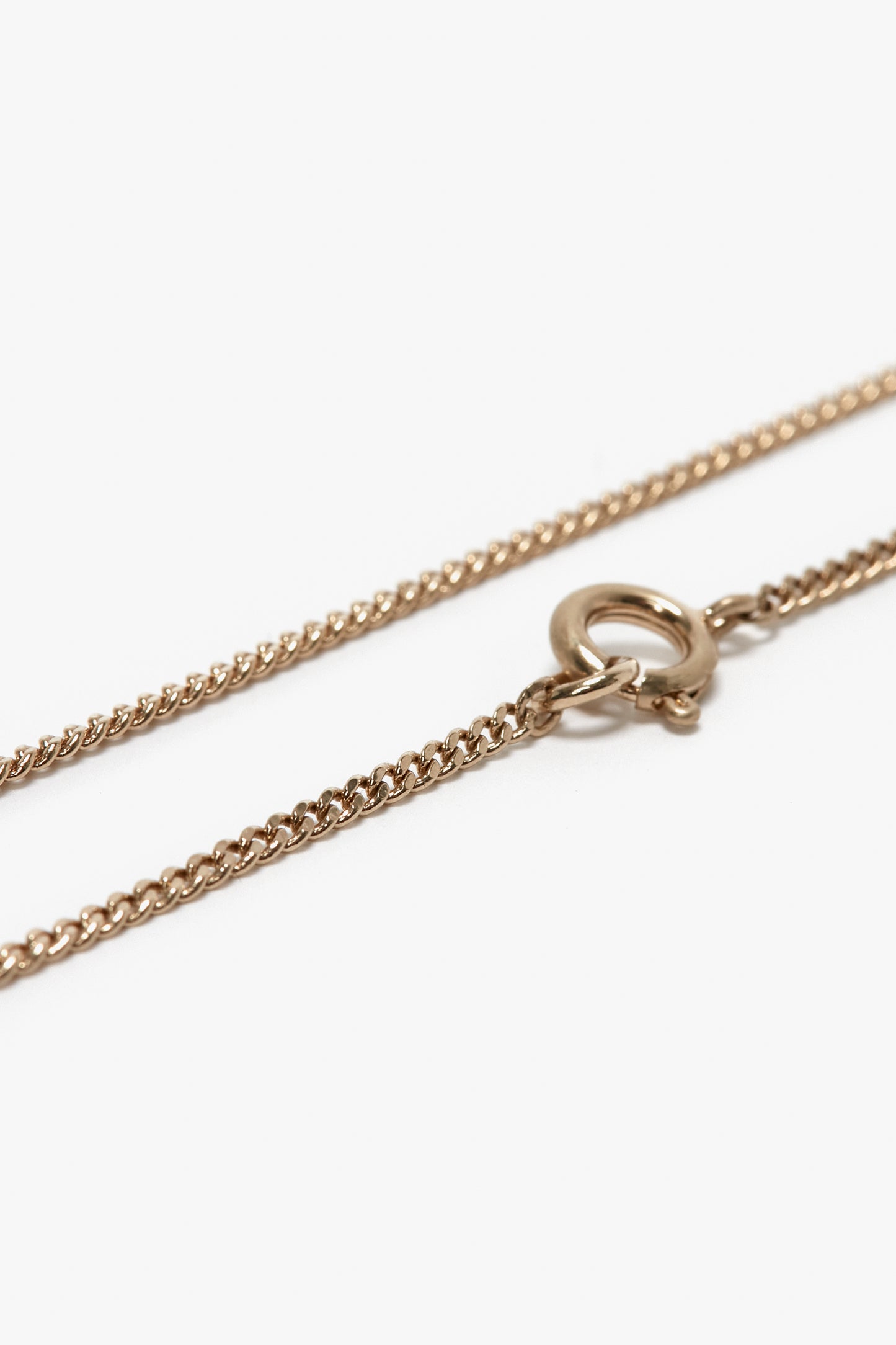 Close-up image of a Victoria Beckham Exclusive Long Fine Chain In Gold with a spring ring clasp.