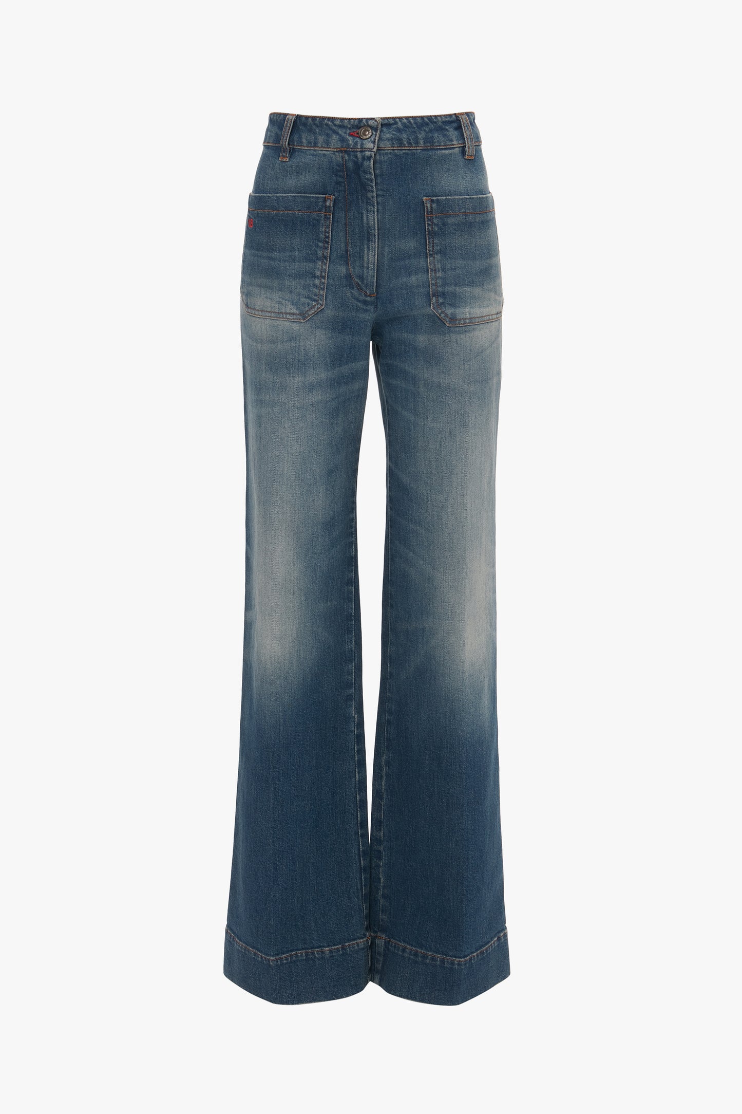 A pair of blue wide-leg jeans with front pockets and a slightly faded, Alina High Waisted Jean In Heavy Vintage Indigo Wash design, reminiscent of Victoria Beckham's tailored jeans.