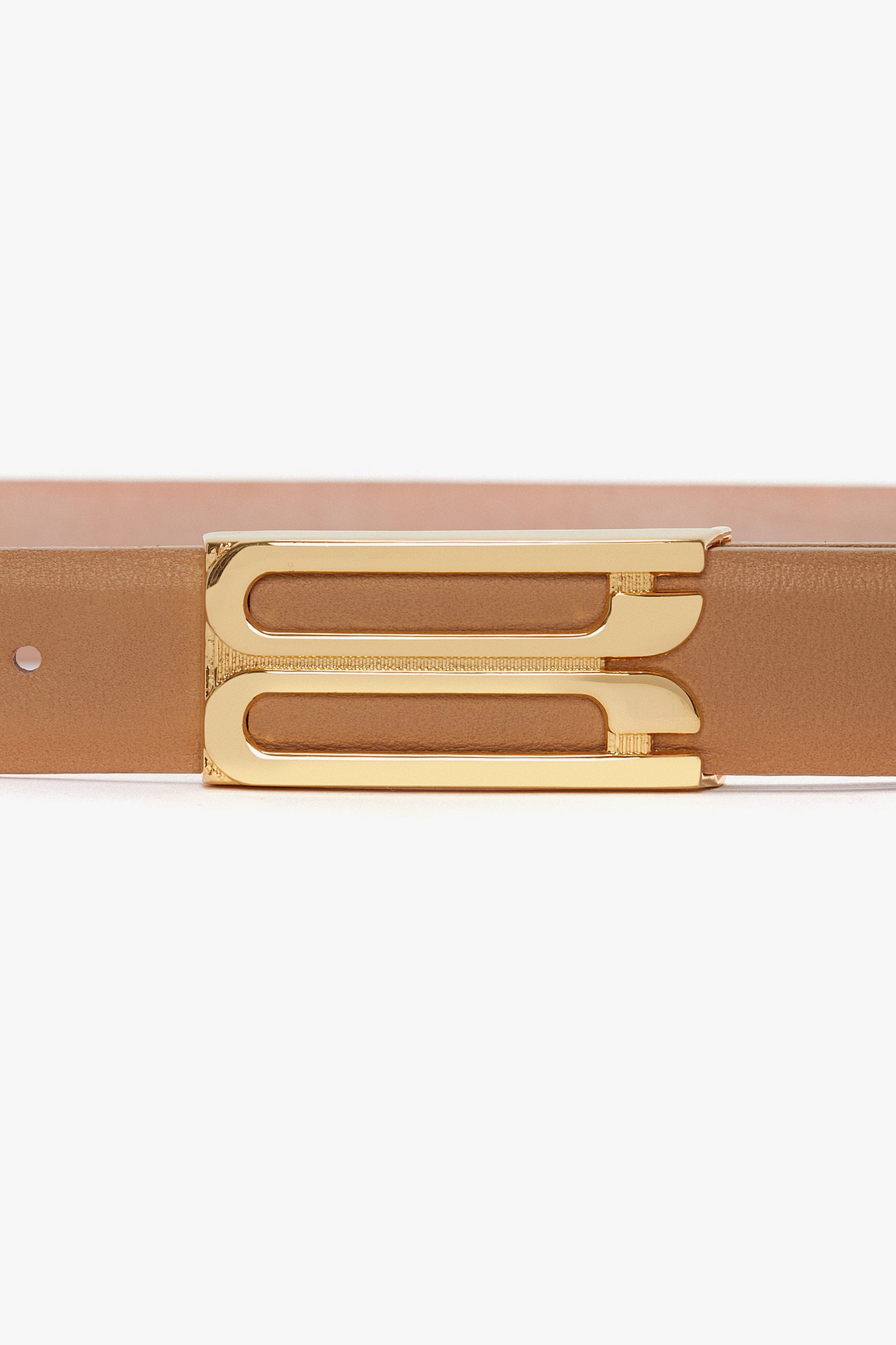 Close-up image of the Victoria Beckham Frame Belt In Camel Leather, showcasing luxury gold hardware with a double-bar design.