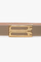 A fashion-forward beige belt with a gold rectangular frame buckle featuring two cutouts, the Exclusive Frame Belt In Beige Leather by Victoria Beckham.