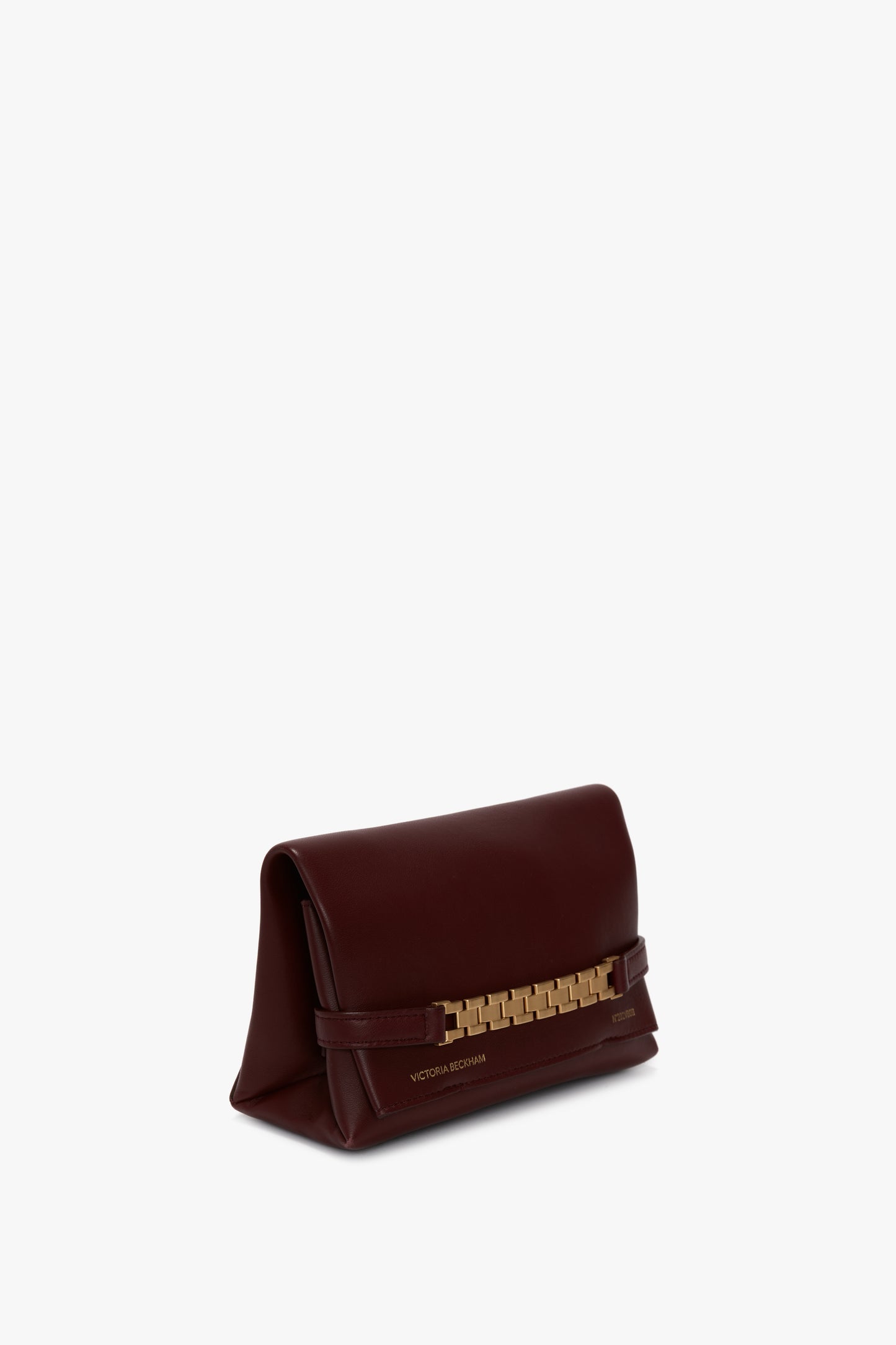 A Mini Chain With Long Strap Pouch Bag In Burgundy Leather featuring a gold rectangular link chain detail on the front and "Victoria Beckham" inscribed at the bottom, crafted from luxurious burgundy leather with a detachable strap.