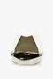 Top view of an open Chain Pouch Bag with Strap In White Leather by Victoria Beckham, revealing a green interior lining and a zippered pocket.