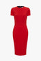 Victoria Beckham's bright red knee-length fitted T-shirt dress with short sleeves and a round neckline, isolated on a white background.