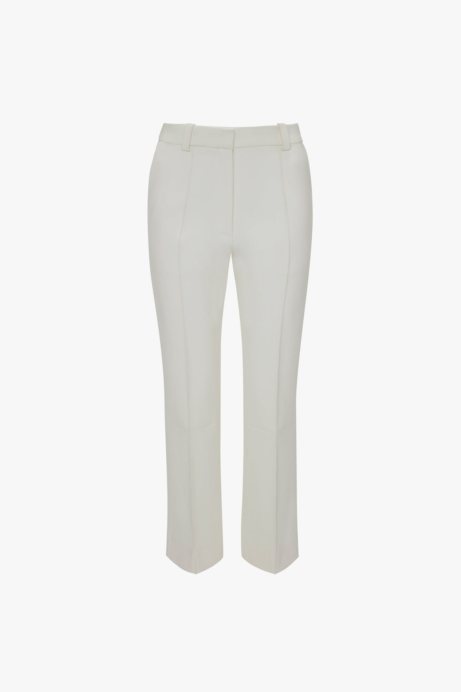 A pair of Cropped Kick Trousers In Ivory by Victoria Beckham with belt loops and stitched seams, shown flat on a white background.