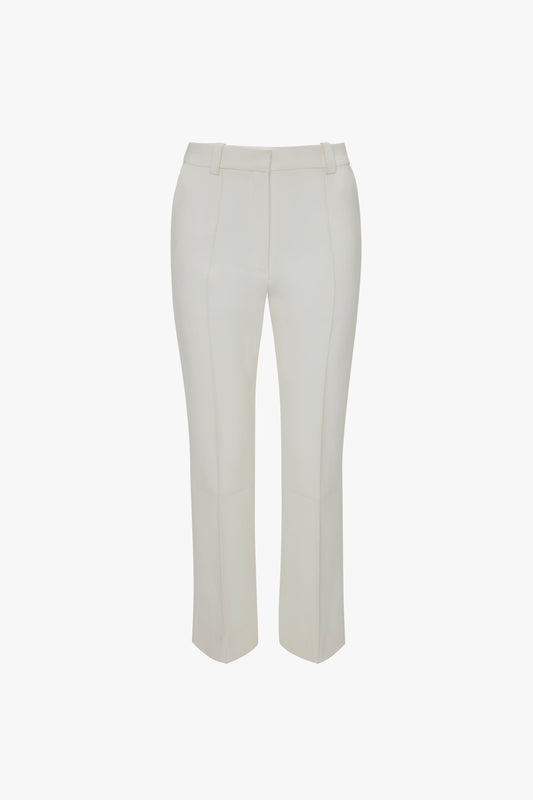 A pair of Cropped Kick Trousers In Ivory by Victoria Beckham with belt loops and stitched seams, shown flat on a white background.