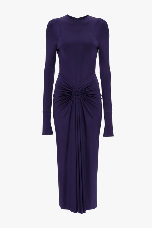 A long-sleeved, dark purple Long Sleeve Gathered Midi Dress In Ultraviolet by Victoria Beckham with a sensuous and playful design, featuring a form-fitting silhouette in body-sculpting stretch fabric and ruched detail at the waist, extending into a gathered front drape.