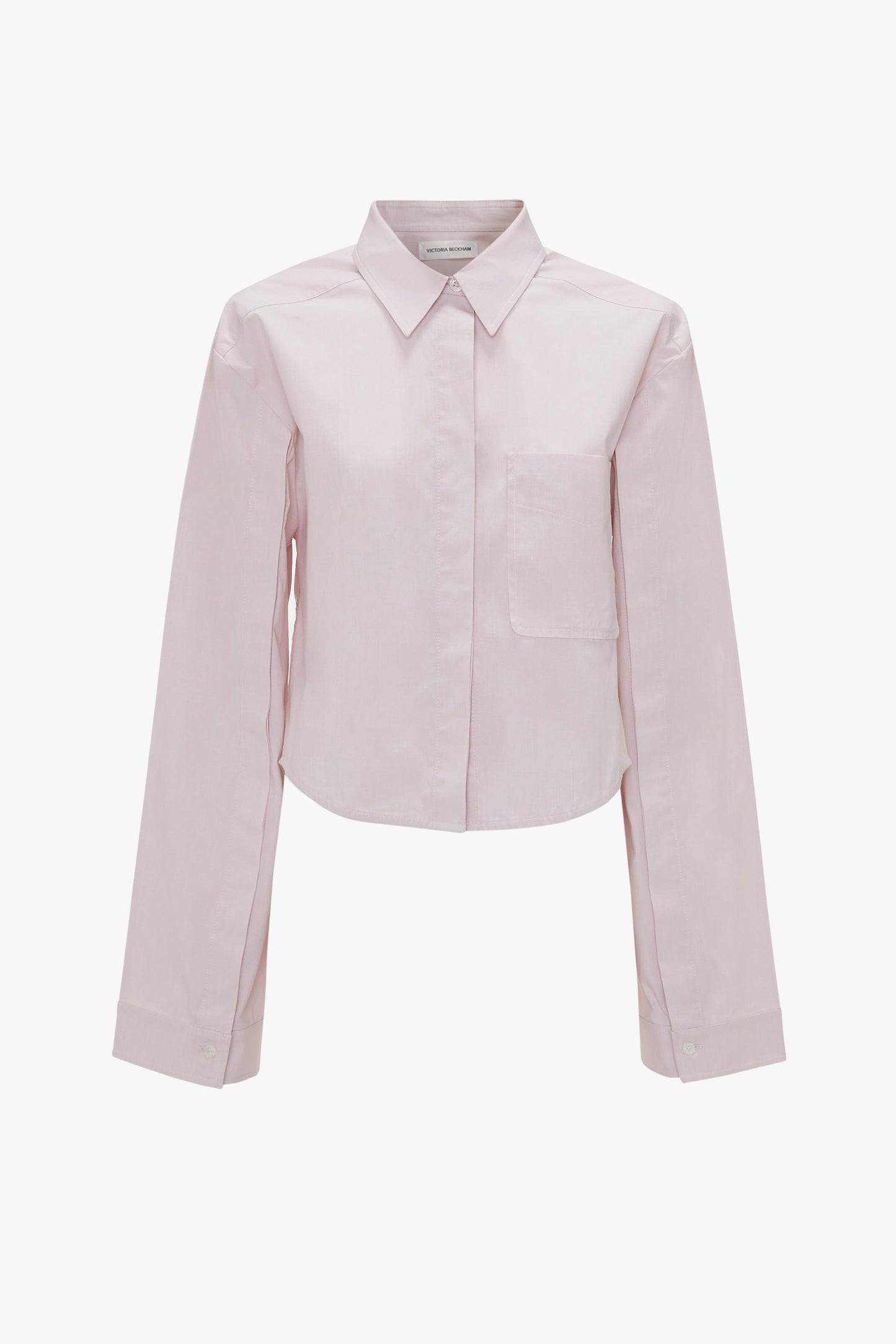 A light pink Victoria Beckham Button Detail Cropped Shirt In Rose Quartz with a chest pocket, collar, and refined button sleeve detail.