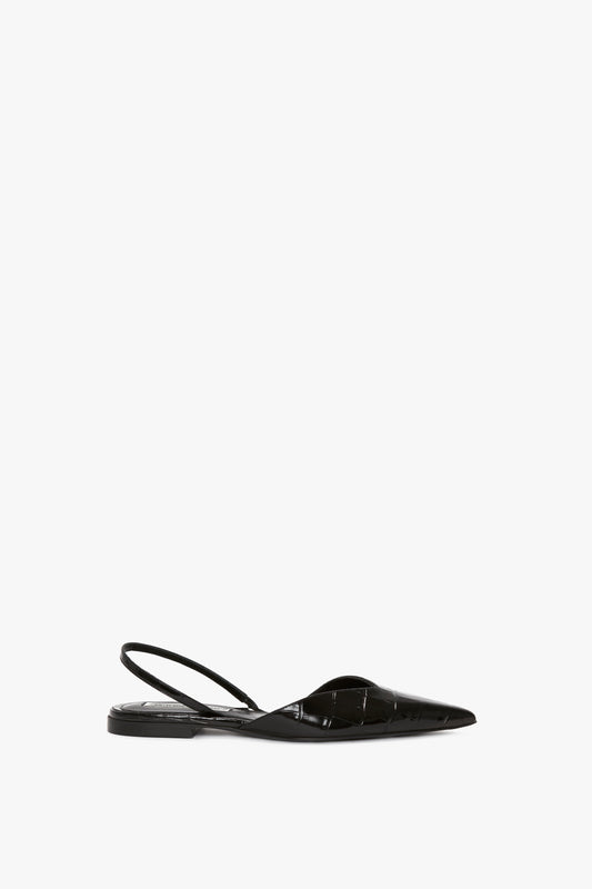 A Victoria Beckham V Cut Sling Back In Black Croc-Effect Leather, featuring a thin strap across the heel and an asymmetric V cut, crafted from croc-embossed calf leather, set against a white background.