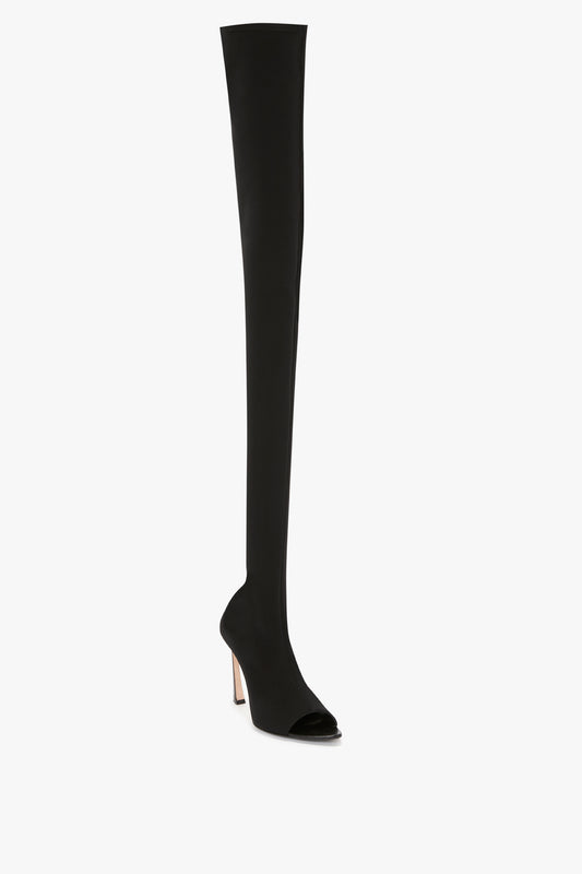 Black Peep Toe Stretch Jersey Boot in Black with a slim sculptural stiletto heel, shown against a plain white background. This Victoria Beckham footwear piece exudes elegance and sophistication.