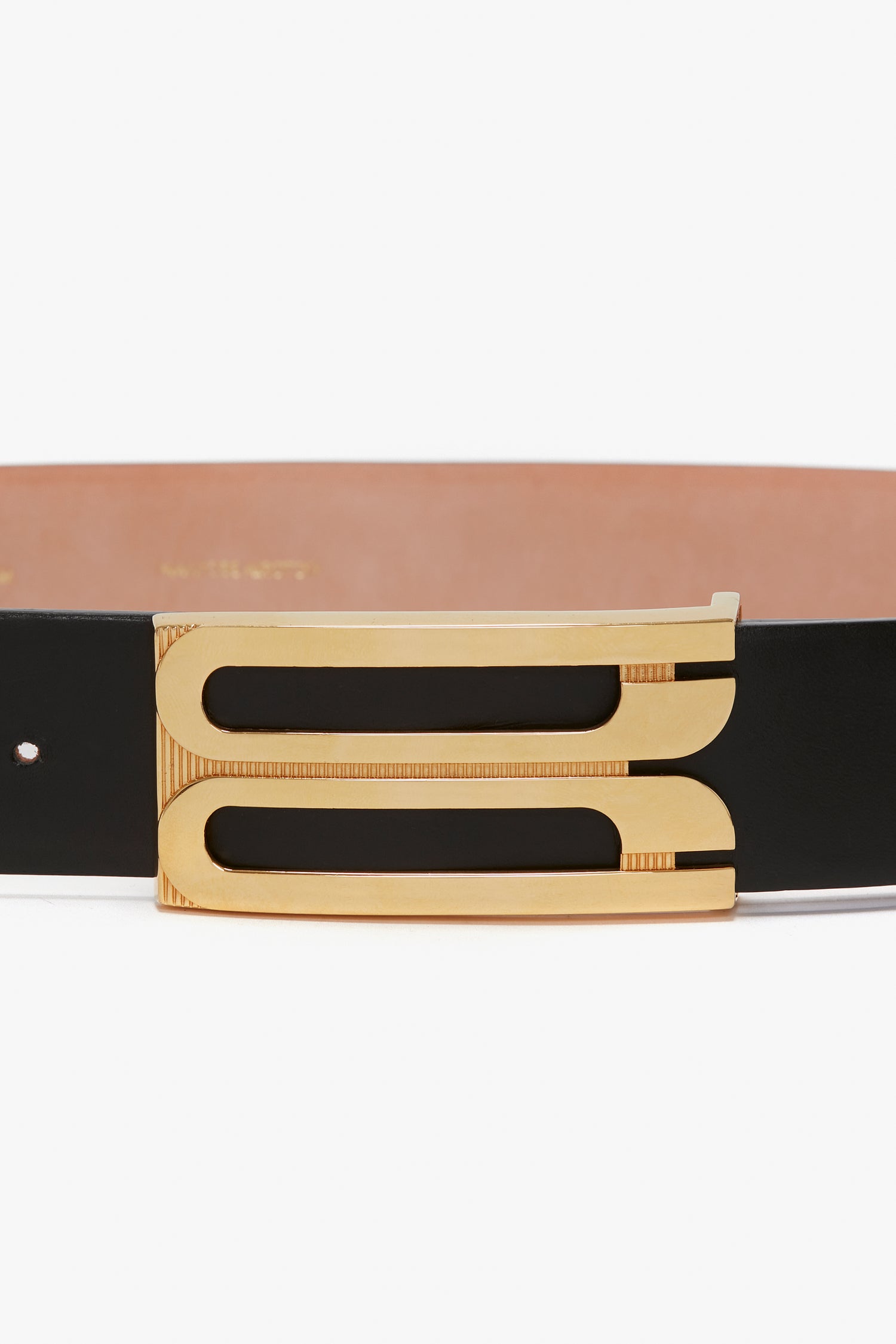 A Jumbo Frame Belt In Black Leather with a gold rectangular buckle featuring two elongated cut-out designs, crafted from smooth calf leather by Victoria Beckham.