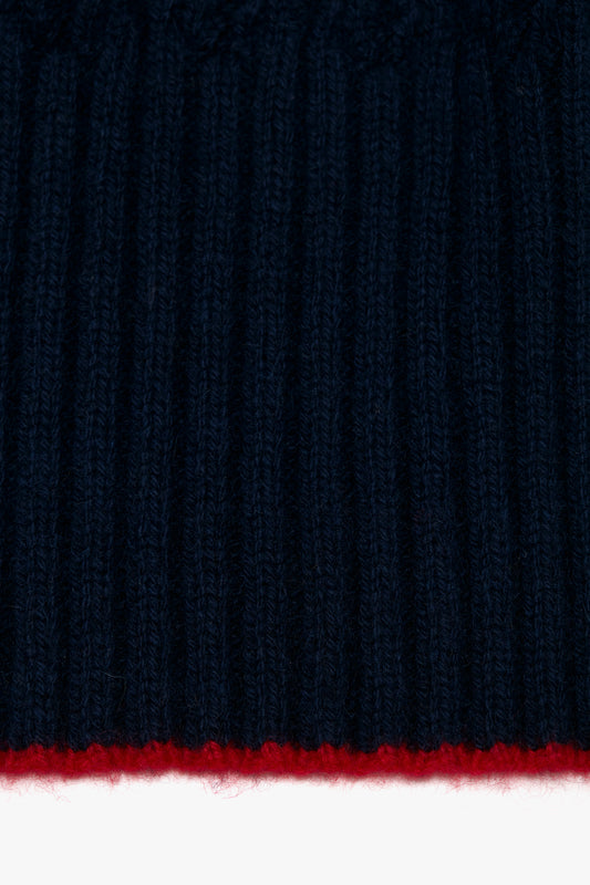 Close-up of a navy Exclusive Logo Patch scarf with a thin red stripe at the bottom and a Victoria Beckham logo patch.