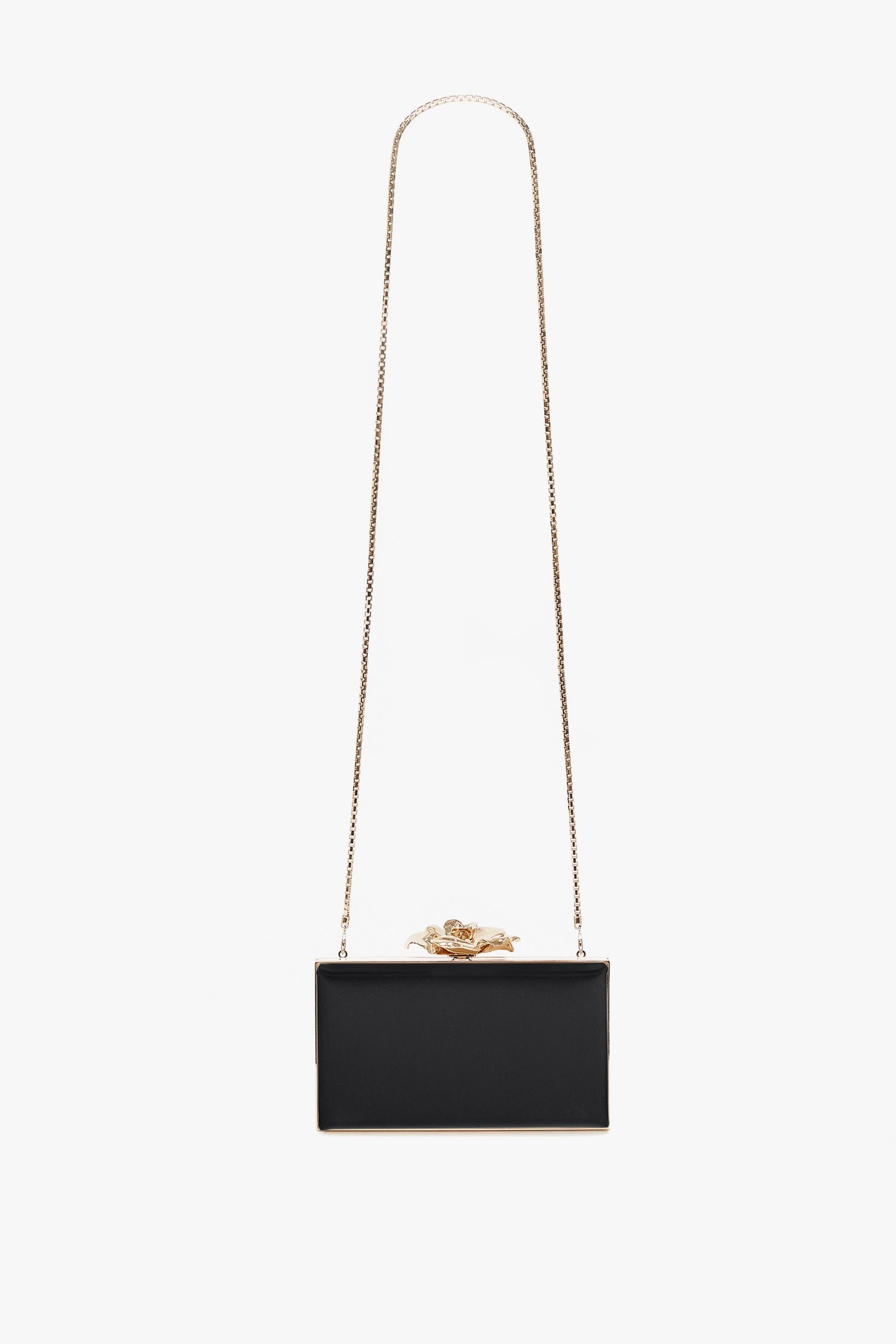 A small rectangular black handbag with a bespoke brass frame and a gold lion clasp, featuring a long gold chain strap, the Frame Flower Minaudiere Bag in Black by Victoria Beckham.