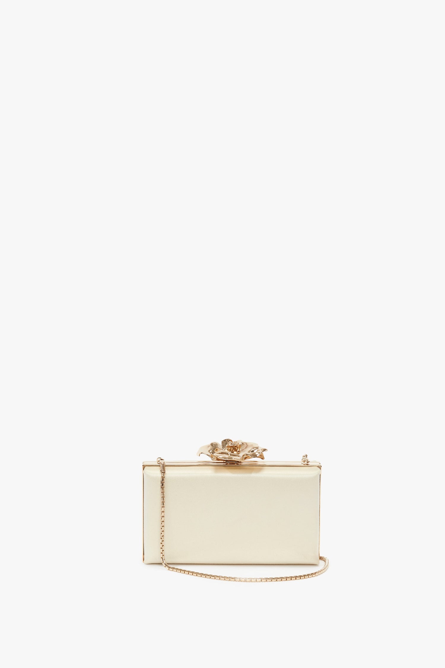 A small rectangular gold Frame Flower Minaudiere in Bag Chamomile with a metallic finish, a decorative clasp on top, and a thin chain strap, perfect for adding a touch of luxury to your accessories collection. Inspired by Victoria Beckham's elegant style.