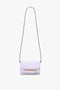 A light purple, or lilac, shoulder bag with a long, thin detachable strap and an Exclusive Mini Chain Pouch Bag With Long Strap In Lilac Leather by Victoria Beckham detail on the front.