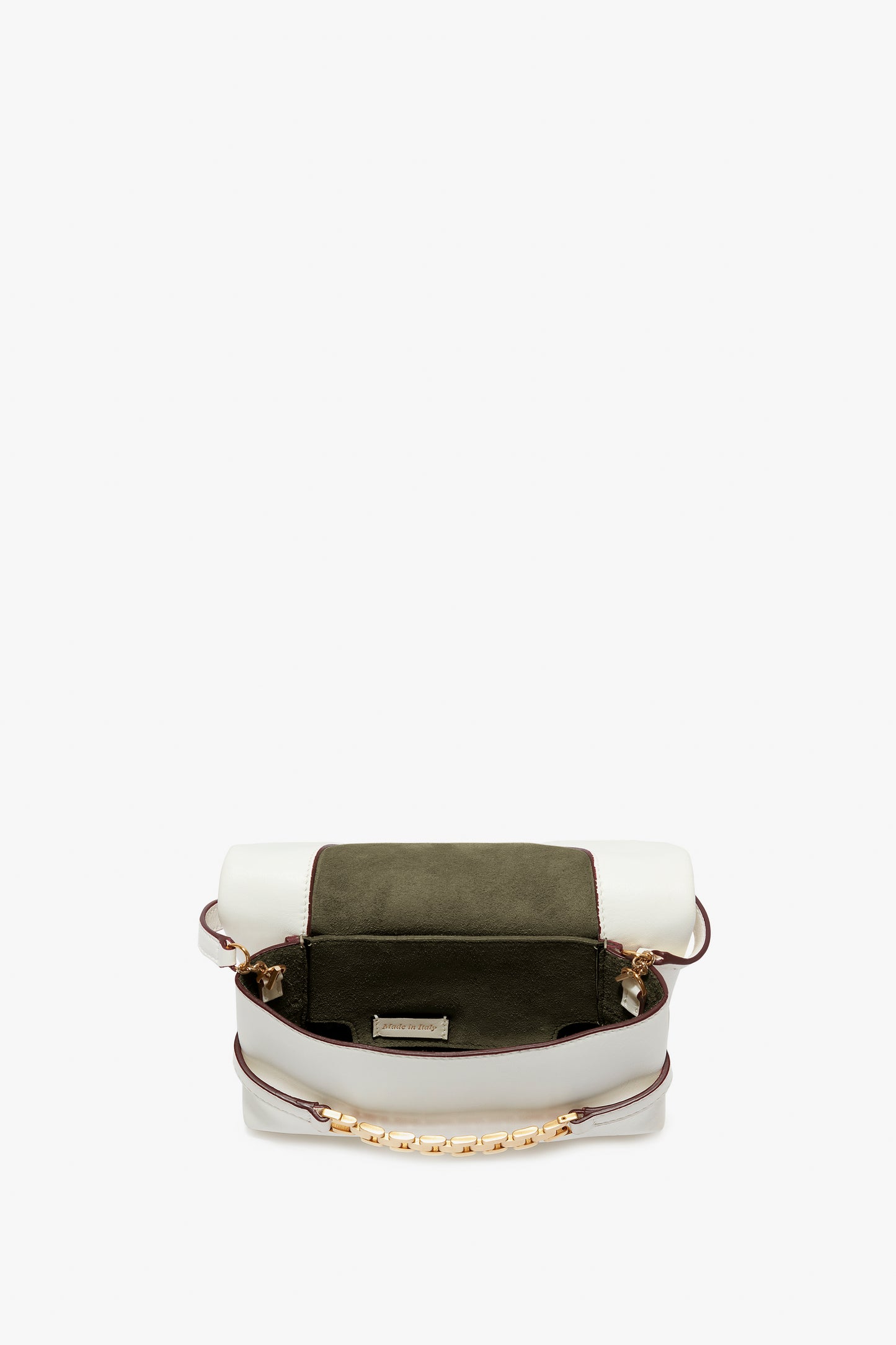 A small, open satchel-style handbag with a white exterior, green suede flap, and gold-tone chain accents. Inspired by Victoria Beckham's Mini Chain Pouch Bag With Long Strap In White Leather, it boasts a single compartment and a small pocket inside. The addition of a removable strap adds versatility to this chic accessory.