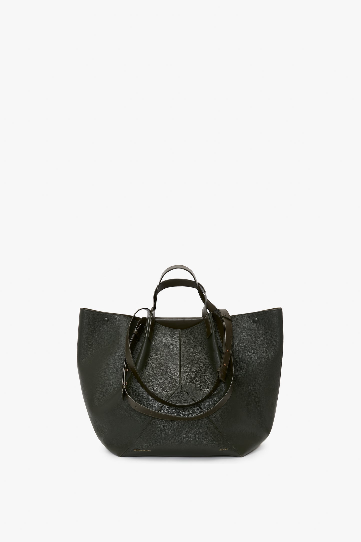 A luxurious, black leather W11 Jumbo Tote Bag In Loden Leather with double top handles and a detachable shoulder strap is displayed against a white background. The bag features sophisticated grained leather and adjustable straps for versatile wear by Victoria Beckham.