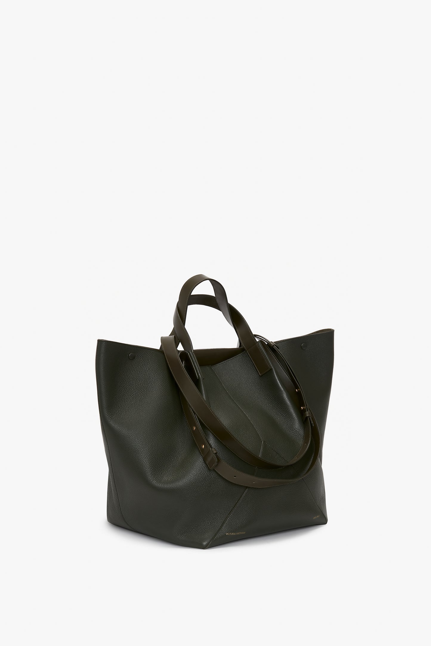 A large, dark green Victoria Beckham W11 Jumbo Tote Bag In Loden Leather with dual handles and extended adjustable shoulder straps on a plain white background.