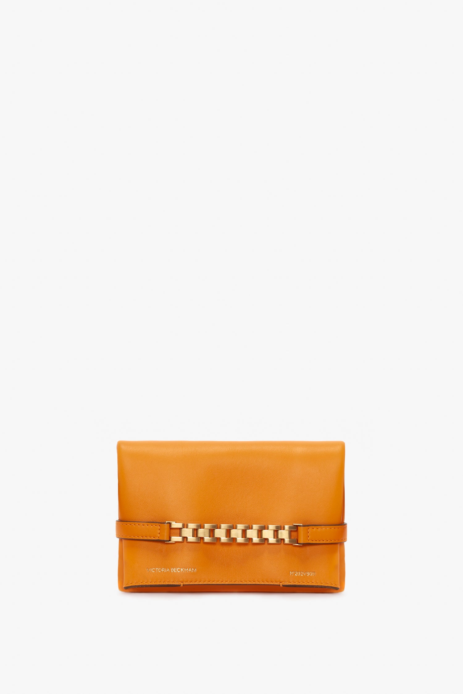 A bright mandarin clutch purse with a gold chain detail on the front and small gold text at the bottom, featuring a detachable long strap for versatile wear. Introducing the Mini Chain Pouch Bag With Long Strap In Mandarin Leather by Victoria Beckham.