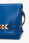 Mini Chain Pouch Bag With Long Strap In Sapphire Blue by Victoria Beckham with gold chain detail, featuring an embossed number "N°202VB011" on the front flap.