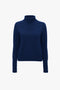 A Polo Neck Jumper In Navy by Victoria Beckham with a plain design and a subtle saddle shoulder design, displayed against a white background.