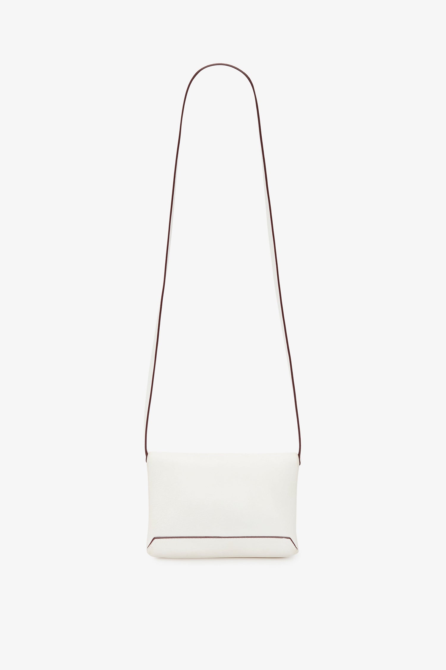 A minimalist white crossbody bag with a long, thin strap and a small rectangular body. The edges of the Victoria Beckham-inspired bag have subtle dark piping. The Mini Chain Pouch Bag With Long Strap In White Leather by Victoria Beckham comes with a removable strap for versatile styling options against the plain white background.