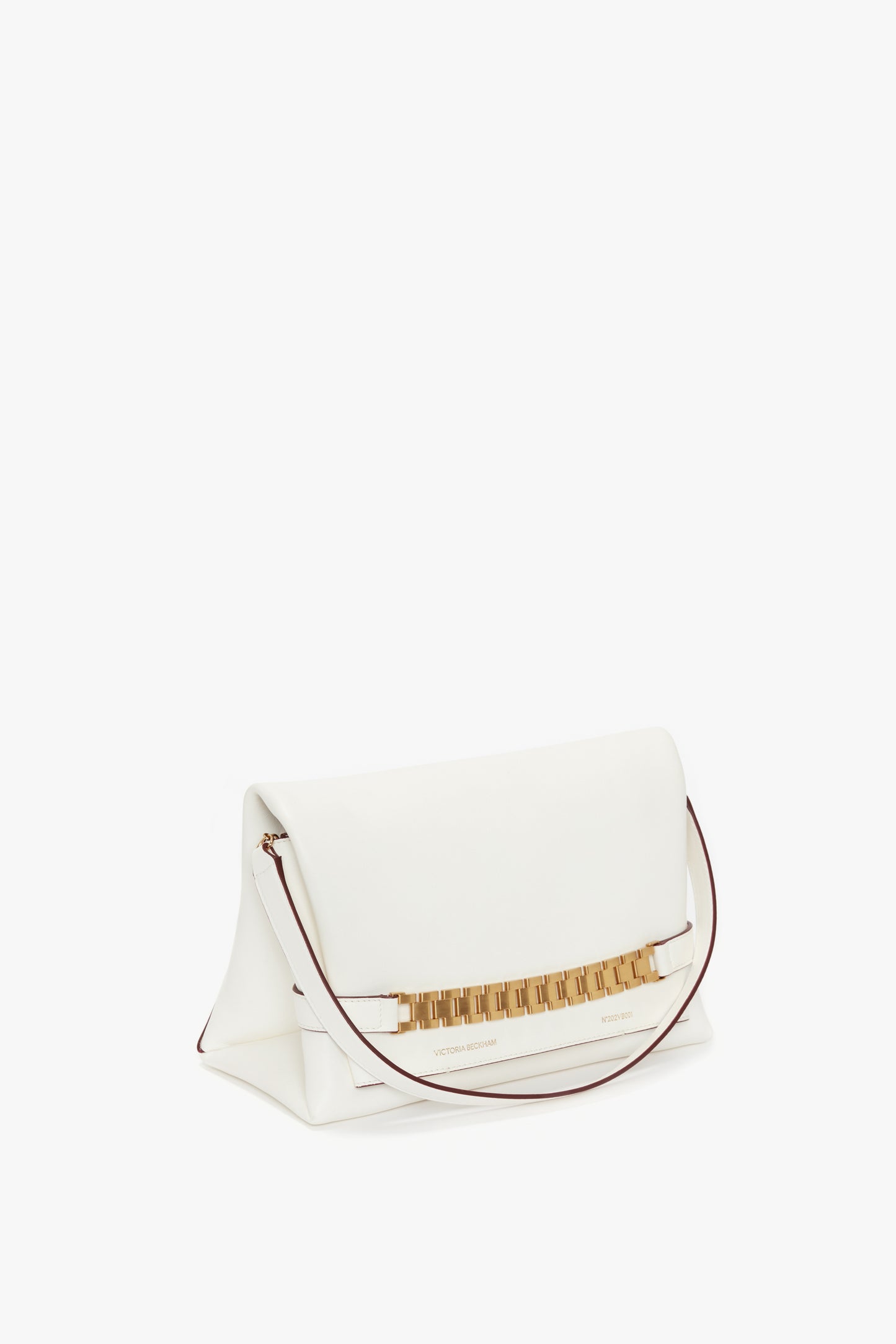 A stylish Victoria Beckham Chain Pouch Bag with Strap In White Leather with a gold decorative clasp and thin shoulder strap, displayed on a plain background.