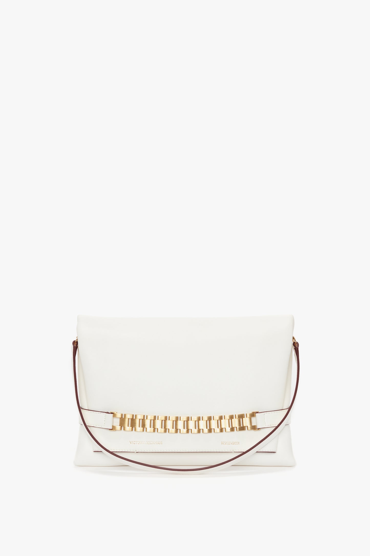 A white Nappa leather clutch handbag with a gold rectangular chain detail across the front and a thin brown strap on each side, embodying the elegance of a Chain Pouch Bag with Strap In White Leather by Victoria Beckham.